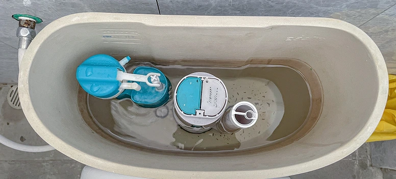 Toilet fill tube correctly positioned inside the tank near the overflow pipe