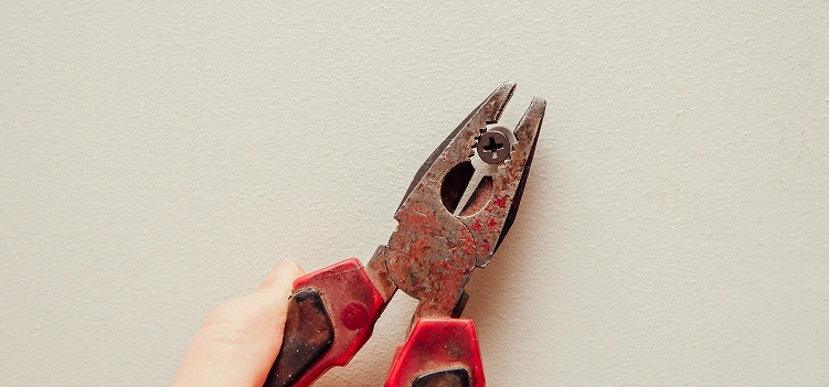 pliers tightly around the screw head